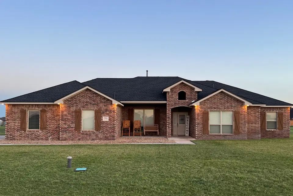 Completed residential roof on a brick home